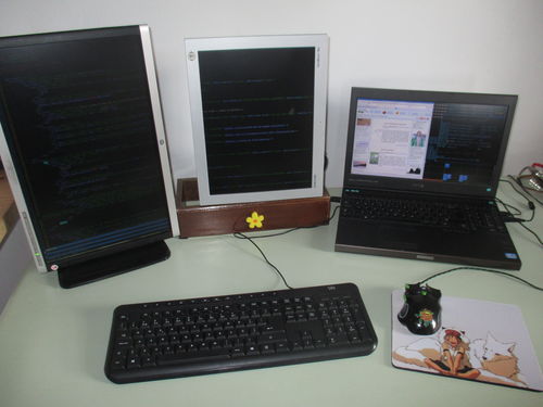 laptop with 2 external monitors used for web development